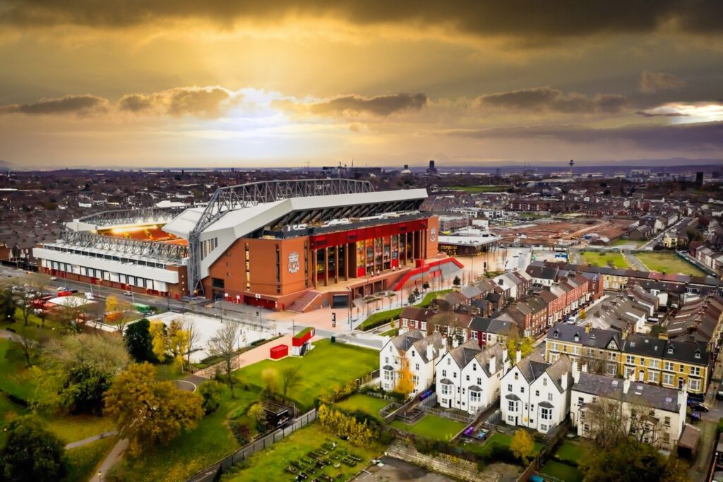 liverpool-fc-legends-tour An aerial view of Anfield Stadium at sunset.