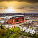 liverpool-fc-legends-tour An aerial view of Anfield Stadium at sunset.